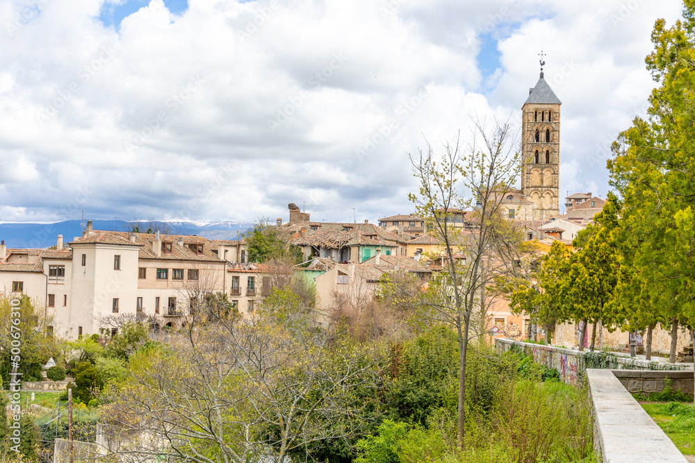 views of the historic buildings in the streets of Segovia with tourists walking under its streets in Segovia views of the historic buildings in the streets of Segovia with tourists walking under its streets in Segovia