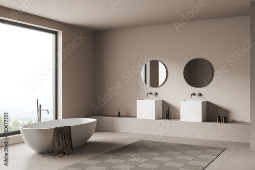 Light bathroom interior with tub and sink  panoramic window and accessories