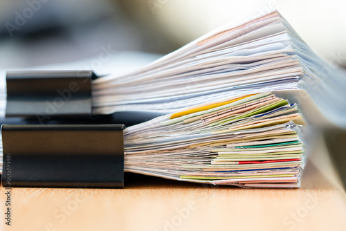 documents achieves paper files for searching information on work desk home office photo