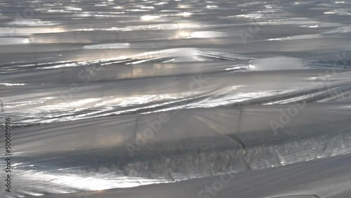 Plastikfolien und Plastikplanen in der Landwirtschaft.
Kultivierung von Spargel im Frühjahr in Deutschland.
Sonnige Reflexe auf der Folie