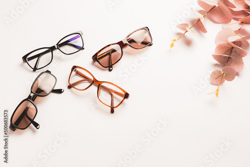 Several trendy stylish glasses on white background with copy space