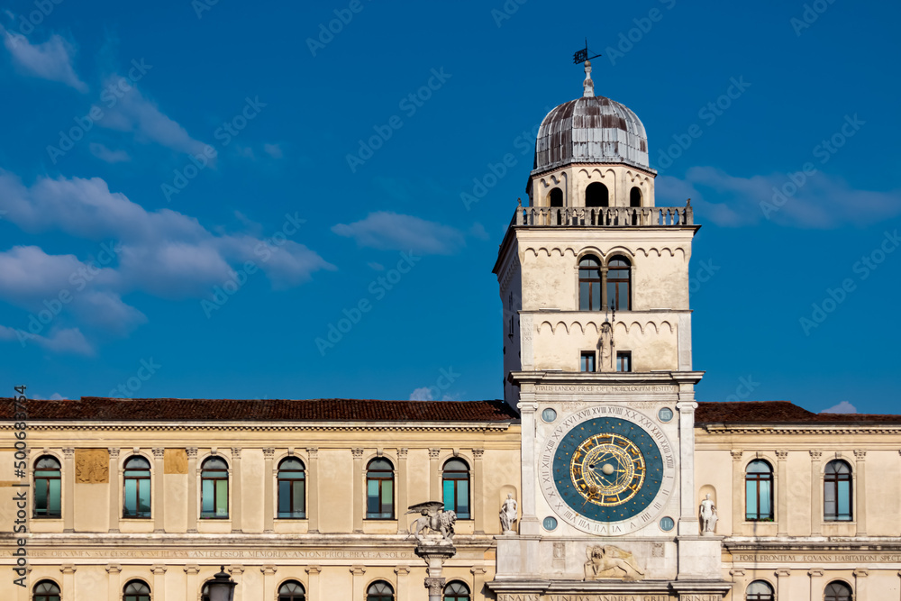 Scenic view on the astronomical clock on Piazza dei Signori in Padua, Veneto, Italy, Europe. Column of the winged lion statue of Saint Mark background Astronomical Clock. Central square in Padova