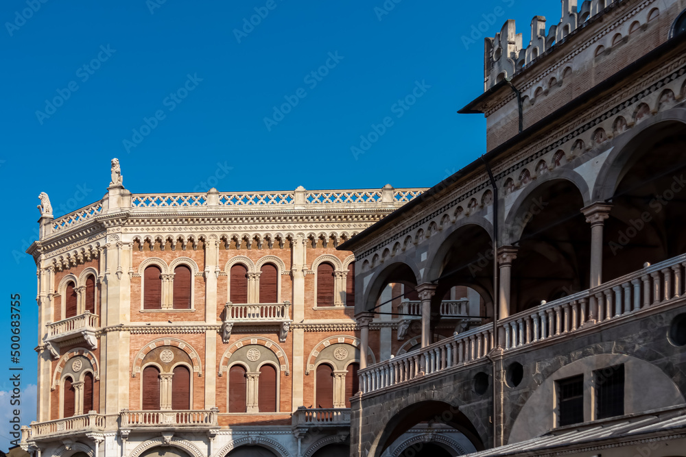 Scenic view from Piazza delle Erbe on the facade of Palazzo Della Ragione on sunny day in Padua, Veneto, Italy, Europe. Typical italian urban architecture with Venetian lion zodiacs and statues.