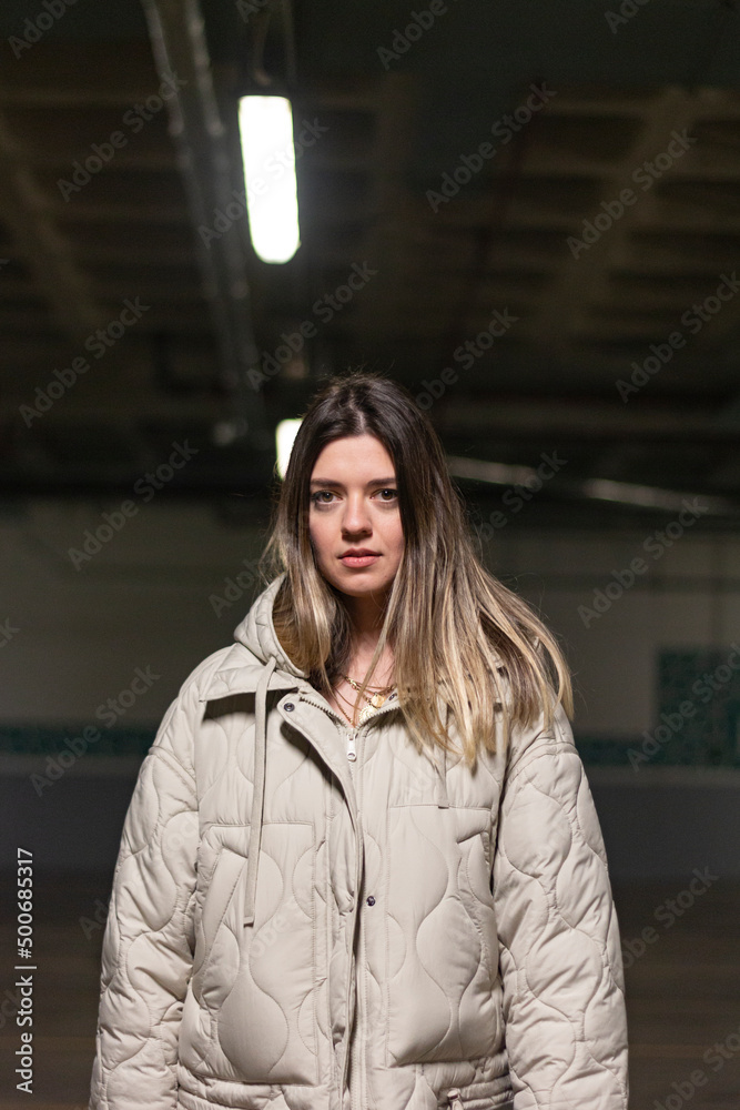 Fototapeta premium Young beautiful woman at dark background.