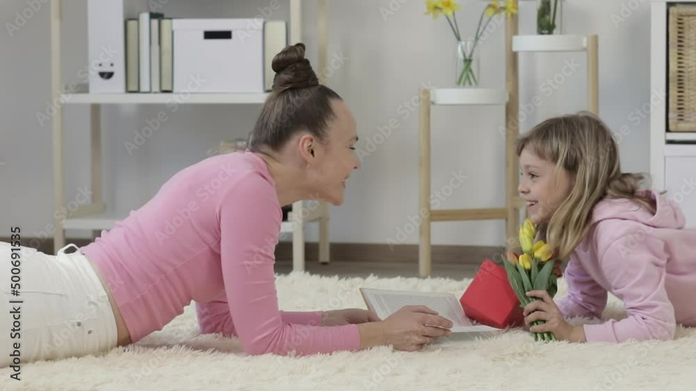 Cute caucasian girl is congratulating her mother with Mother's Day. Cute caucasian girl is congratulating her mother with Mother's Day.