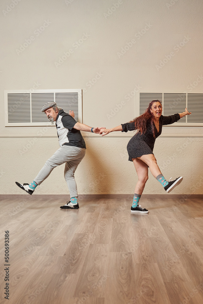 Fototapeta premium Lindy Hop teacher couple in a ballroom