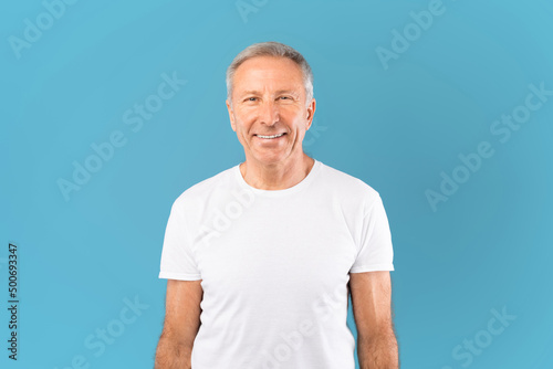 Portrait of happy mature man smiling posing at studio