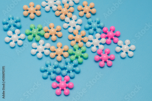 multi-colored plastic snowflakes on a blue background
