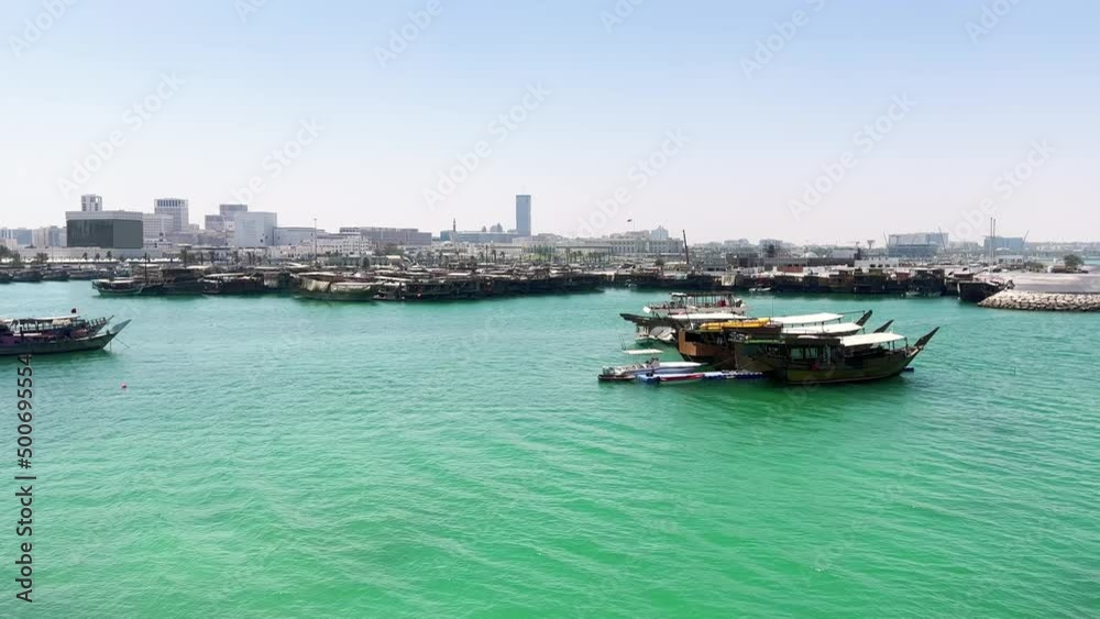 Doha, Qatar: Boats moored at coast, surrounded by emerald waters of Persian Gulf - landscape panorama of Arabian Peninsula from above, West Asia Doha, Qatar: Boats moored at coast, surrounded by emerald waters of Persian Gulf - landscape panorama of Arabian Peninsula from above, West Asia
