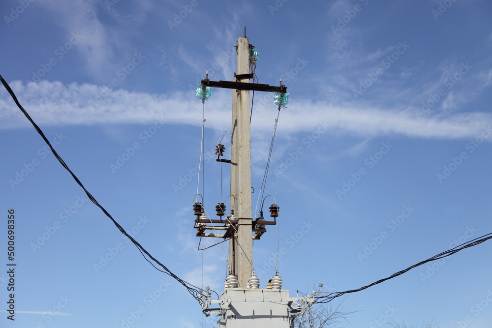 One old electric mast with wires on transformer on blue sky background One old electric mast with wires on transformer on blue sky background