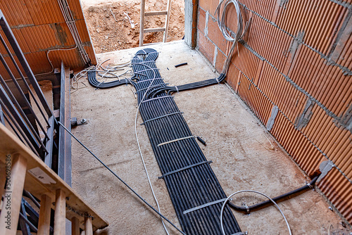 installation of electricity cable in cable canals at the floor photo