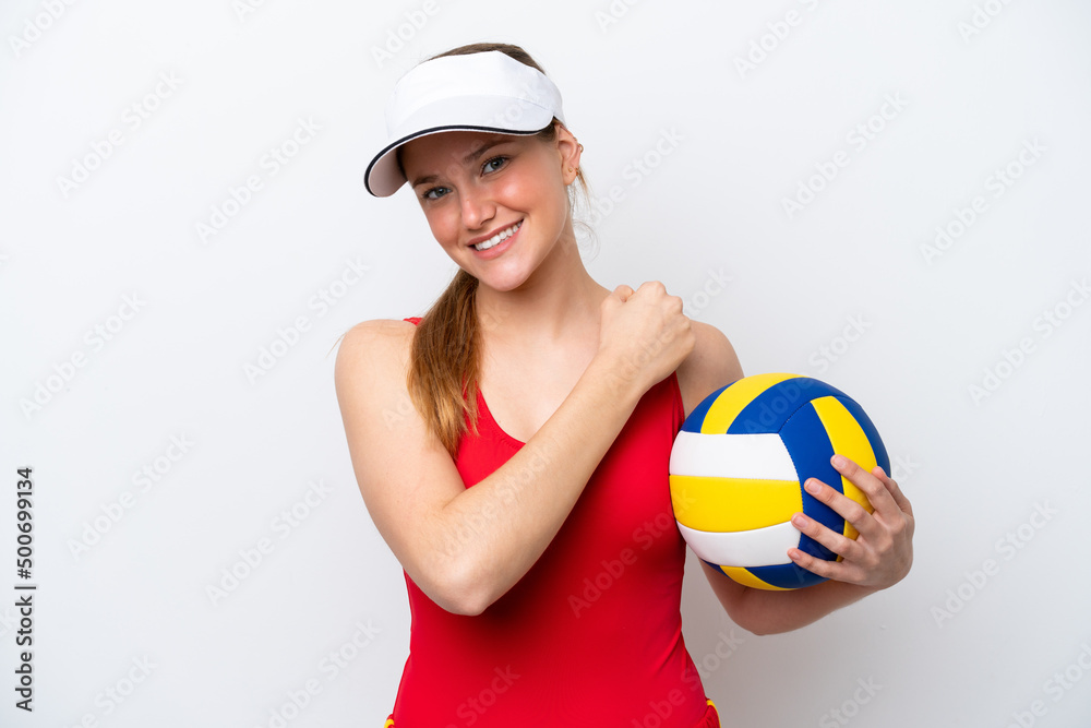 Young caucasian woman playing volleyball isolated on white background celebrating a victory