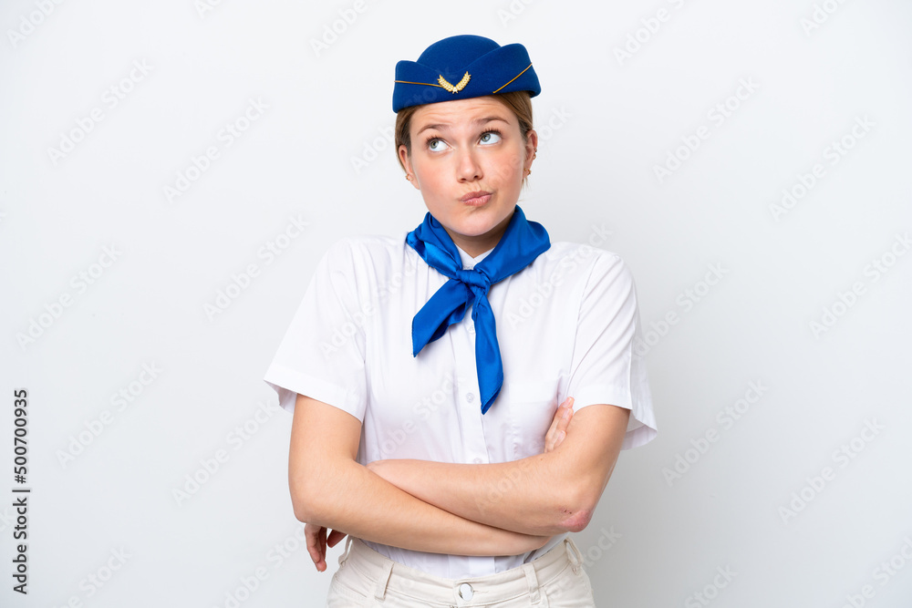Airplane stewardess woman isolated on white background making doubts gesture while lifting the shoulders