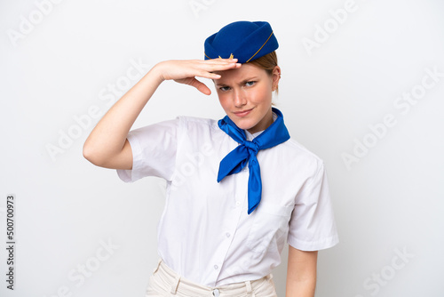 Airplane stewardess woman isolated on white background looking far away with hand to look something