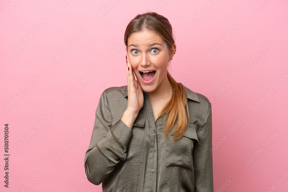 Young caucasian woman isolated on pink background with surprise and shocked facial expression Young caucasian woman isolated on pink background with surprise and shocked facial expression