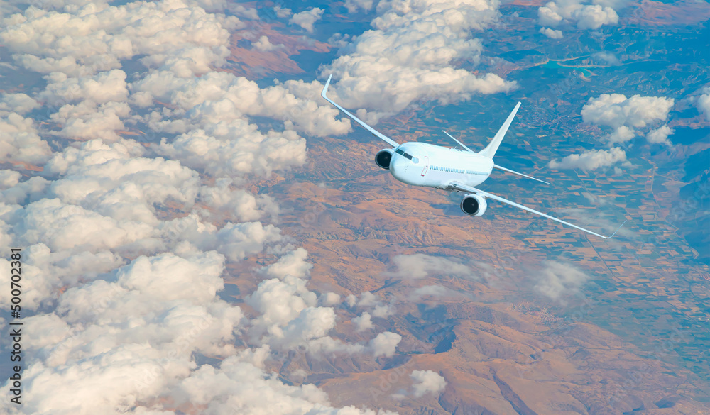 Airplane taking off from the airport - White commercial airplane flying over city and lake Airplane taking off from the airport - White commercial airplane flying over city and lake