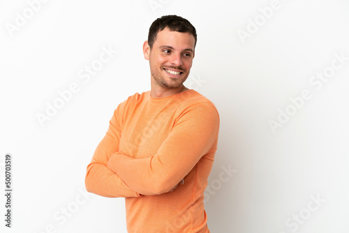 Brazilian man over isolated white background with arms crossed and happy
