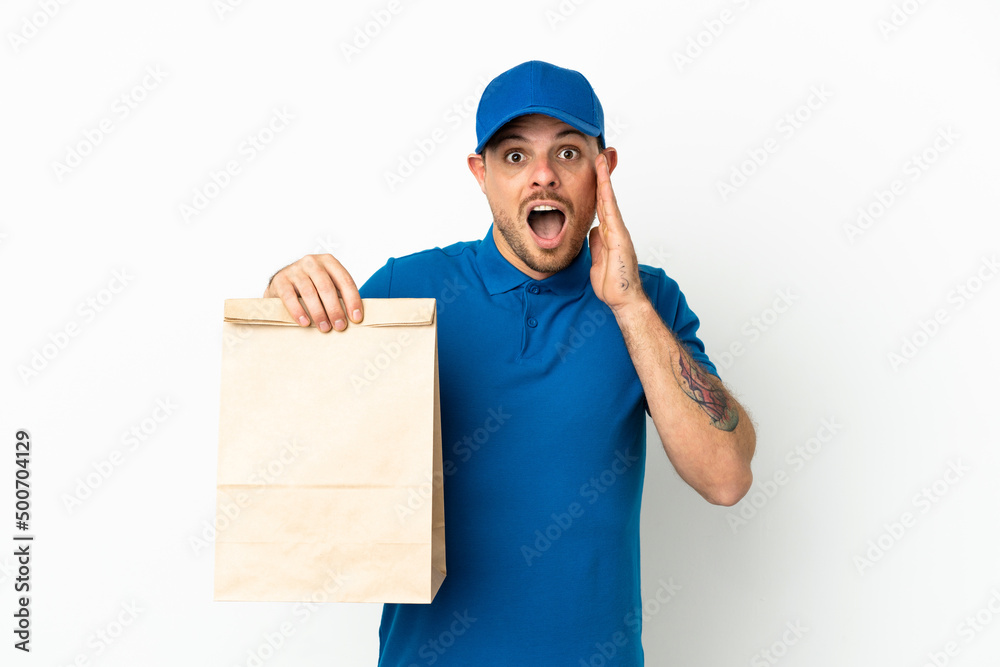 Brazilian taking a bag of takeaway food isolated on white background with surprise and shocked facial expression Brazilian taking a bag of takeaway food isolated on white background with surprise and shocked facial expression