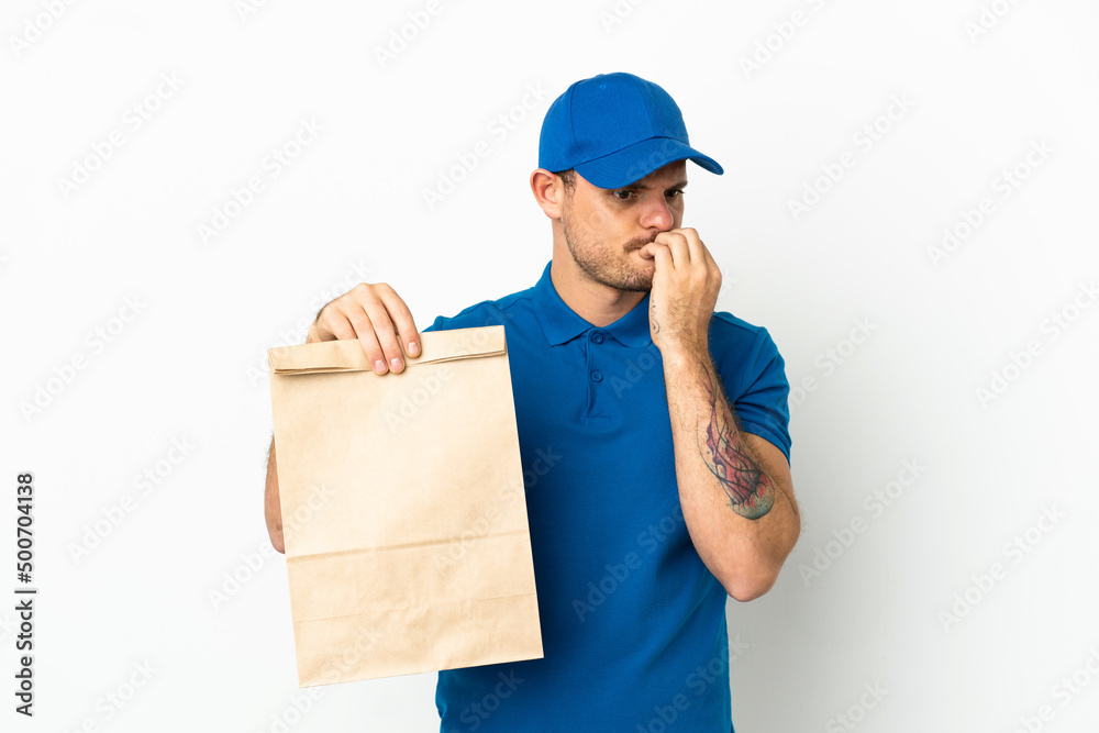 Brazilian taking a bag of takeaway food isolated on white background having doubts Brazilian taking a bag of takeaway food isolated on white background having doubts