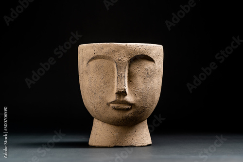 brown pot with a face on it