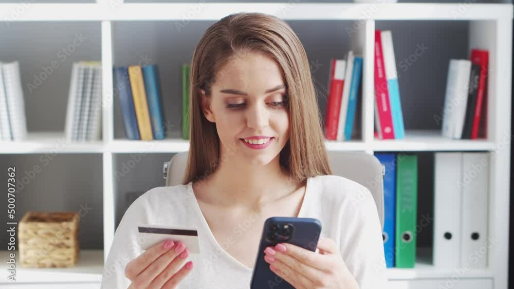 Young Woman Makes online Purchases on the Internet Using a Bank Credit Card. Workplace of Female Entrepreneur, Freelancer or Student. Payment Systems Concept. Young Woman Makes online Purchases on the Internet Using a Bank Credit Card. Workplace of Female Entrepreneur, Freelancer or Student. Payment Systems Concept.