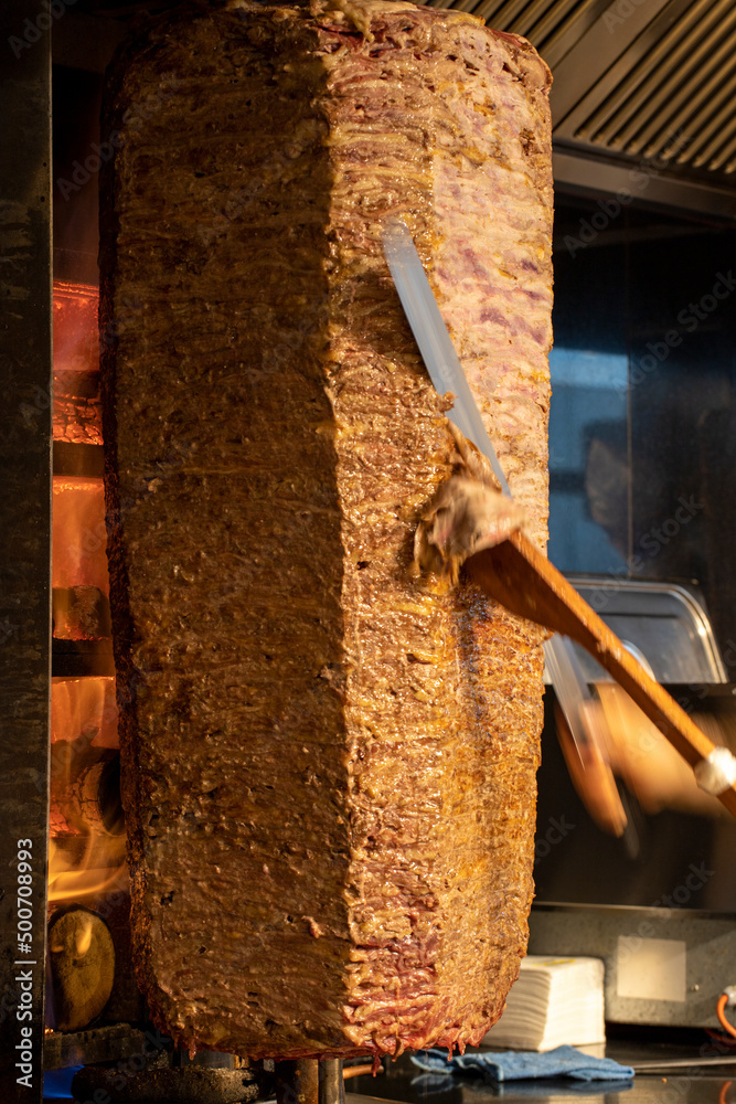 Doner kebab. Turkish doner kebab cooked in wood fire. close up Doner kebab. Turkish doner kebab cooked in wood fire. close up
