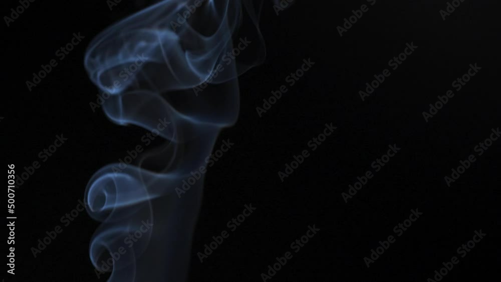 Abstract smoke rises up in beautiful swirls on a black background. Slow motion Abstract smoke rises up in beautiful swirls on a black background. Slow motion