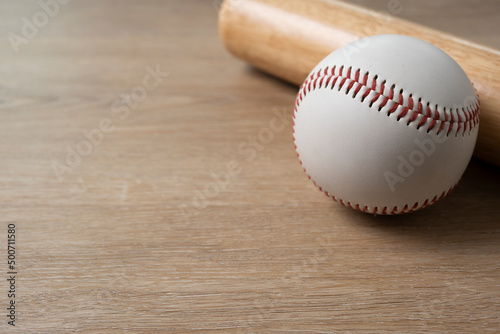Canvas Print Close up baseball and baseball bat on wooden table background, sport concept
