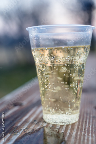 Sparkling Champagne in Plastic Cup, Concept of Alcoholism and Loneliness.