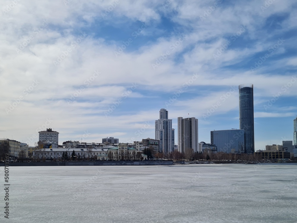 City buildings on the other side of the frozen river