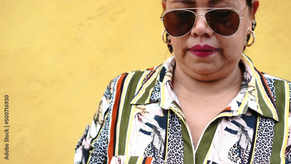 Woman sad in front of yellow wall Woman sad in front of yellow wall