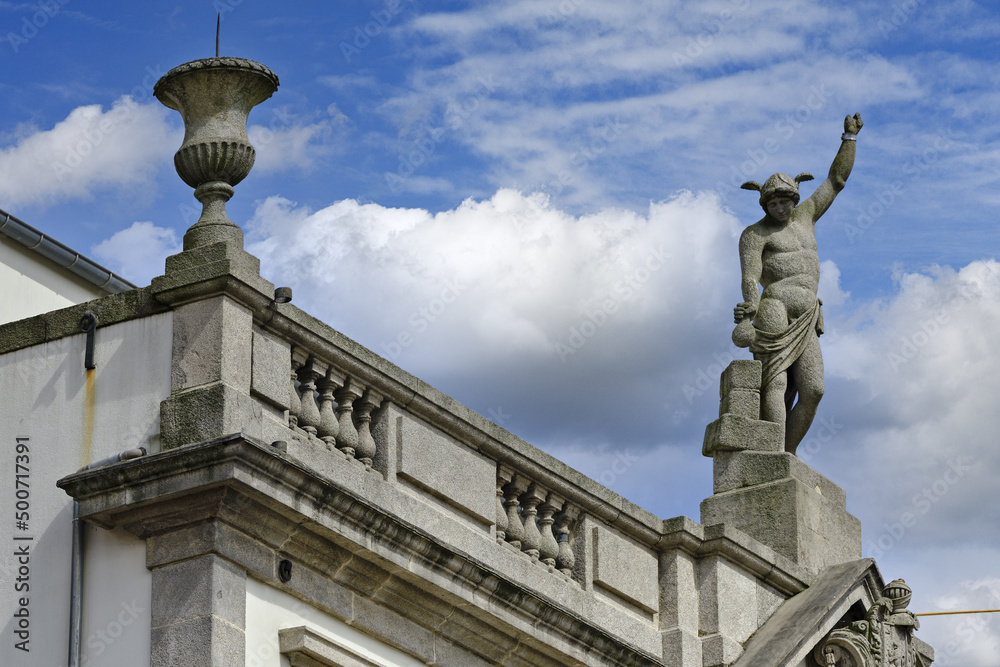 statue and coat of arms on the roof of a patriarchal house in Porto, Portugal