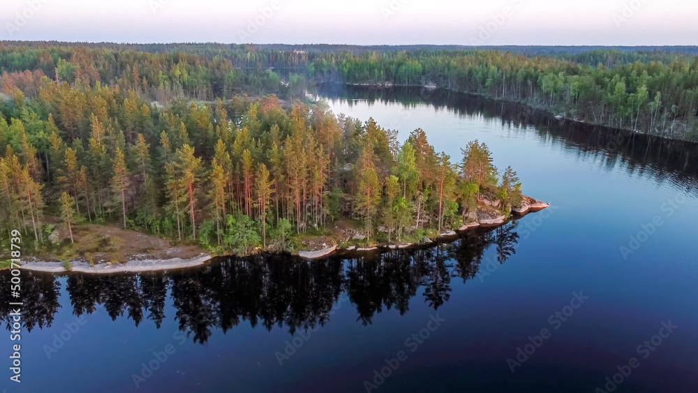 Flight over lakes and forests in Karelia near the village of Kuznechnoye in Russia.