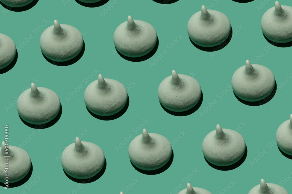 delicious sweet meringues on green background pattern delicious sweet meringues on green background pattern