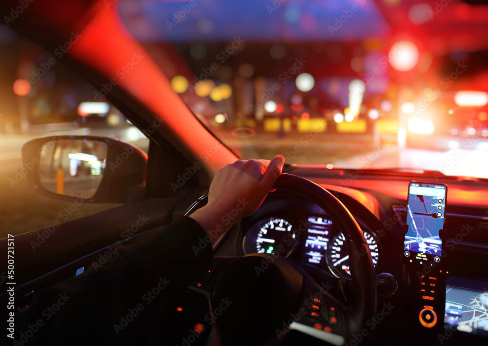 driving a car at night in the city with navigation