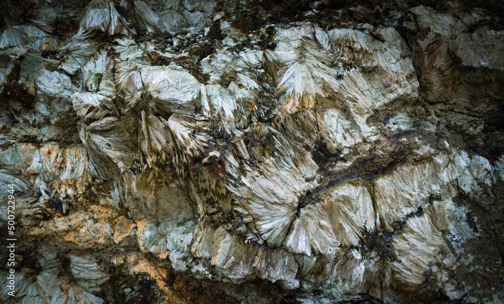 Dark background of natural stone. Detail of a Hedenbergite mineral wall found in Elba island, Italy. Dark background of natural stone. Detail of a Hedenbergite mineral wall found in Elba island, Italy.