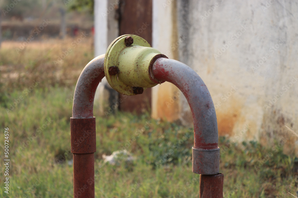 Old borewell motor and pump system with galvanized piping for water outlet with a nonreturn valve designed for irrigation purposes Old borewell motor and pump system with galvanized piping for water outlet with a nonreturn valve designed for irrigation purposes