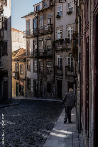 Old man walking down the street in Porto, Portugal