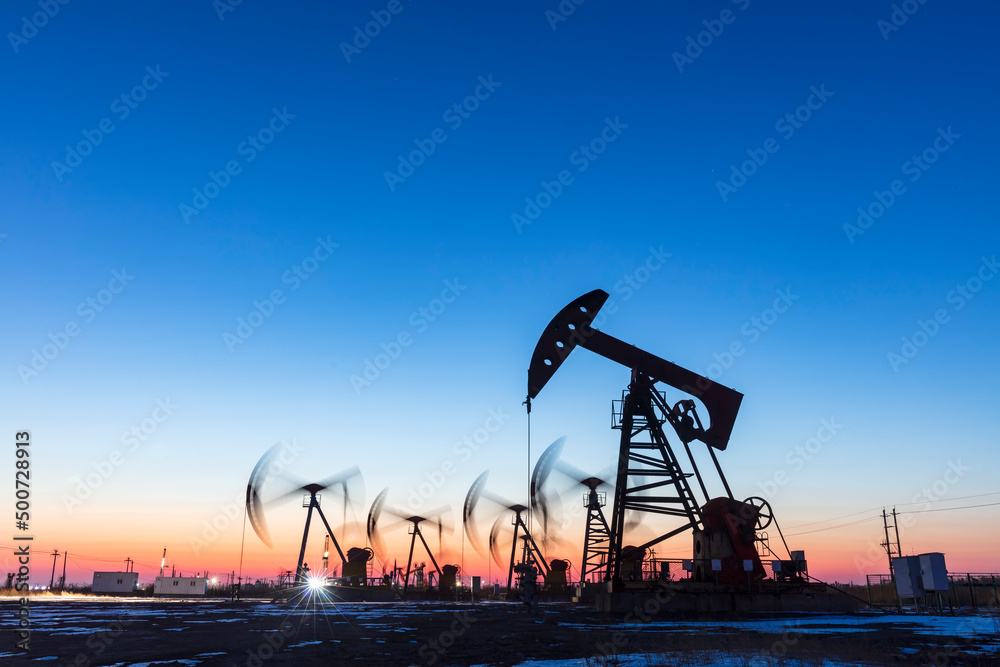 In the evening, oil pumps are running, Silhouette of beam pumping unit