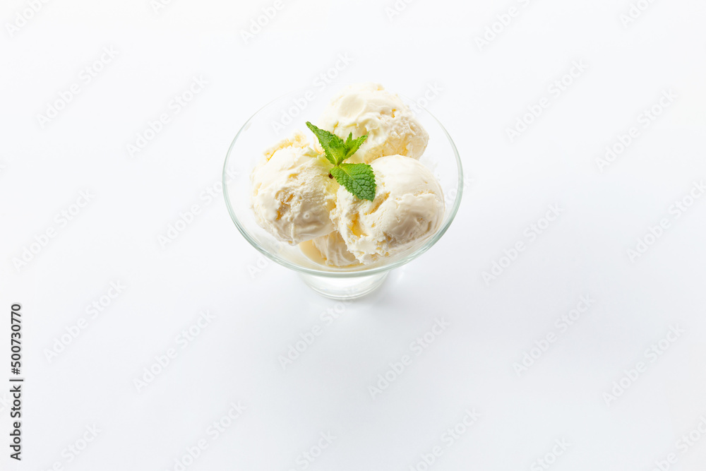 Three scoops of ice cream in a glass bowl. On a white background. Three scoops of ice cream in a glass bowl. On a white background.