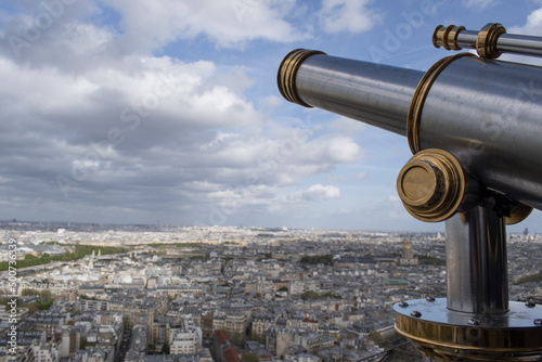 Paris, France, Europe: aerial view seen from the top of the Eiffel Tower with binoculars, the city skyline and the Saint Louis cathedral with its golden dome in the Les Invalides complex
