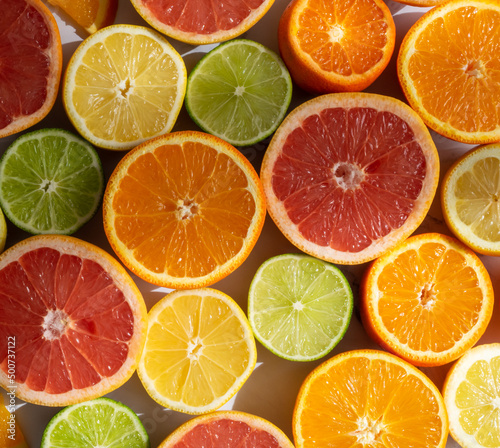 Citrus fruits cut halves arranged beside each other  top view