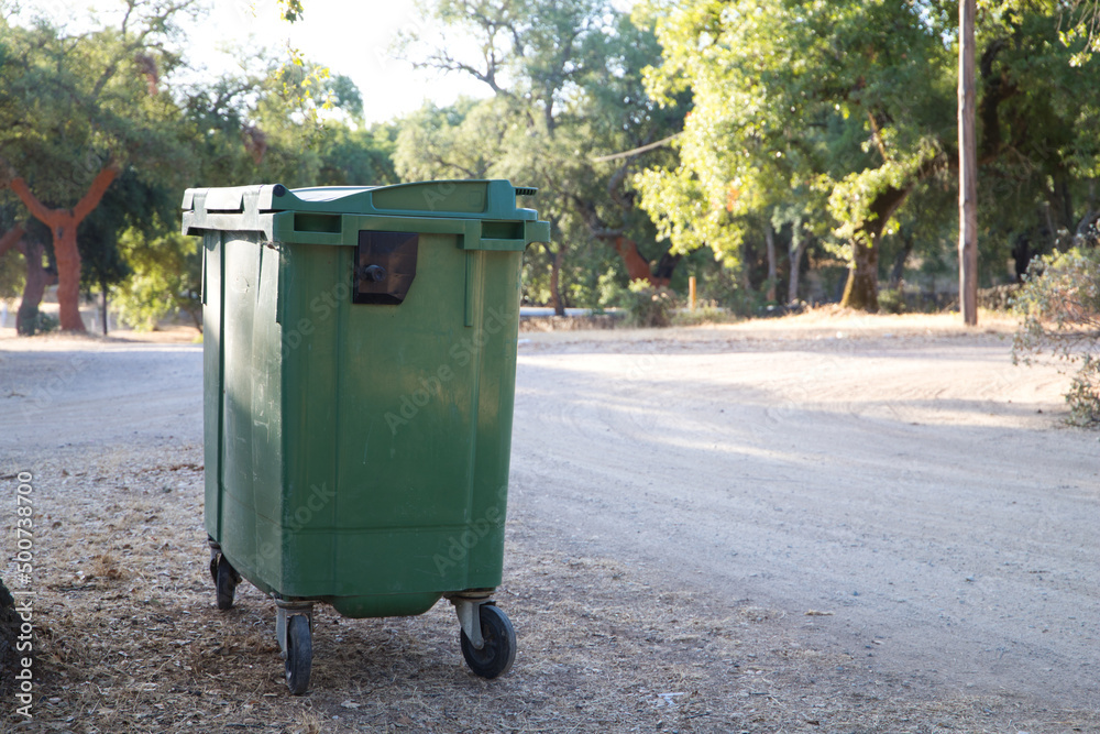 Waste container in a forest in order to recycle and not pollute the environment. Infectious control concept. Waste container in a forest in order to recycle and not pollute the environment. Infectious control concept.