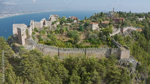 View of the Mediterranean Sea from the ruins of an old stone wall in Alanya, Turkey. Top view from drone.  Alanya beach top view on the mountain with coast on blue sea and harbor city background