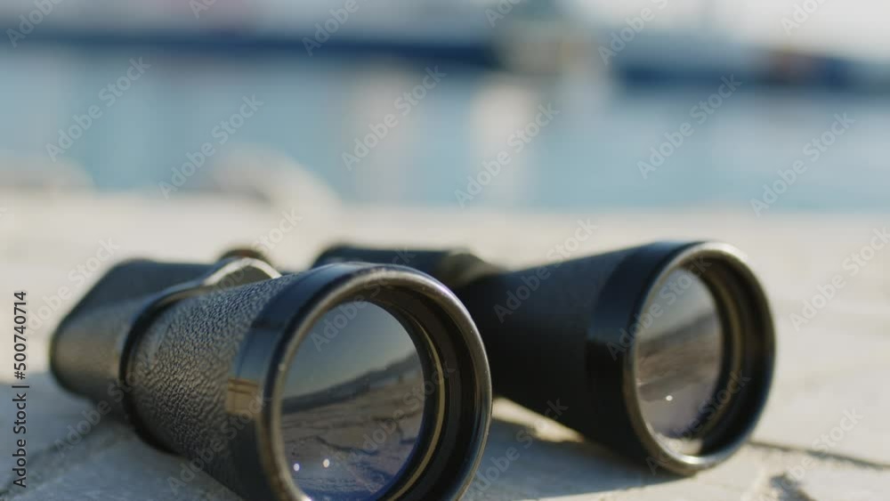 Binoculars of the harbor master's office with blurred ship in the background Binoculars of the harbor master's office with blurred ship in the background