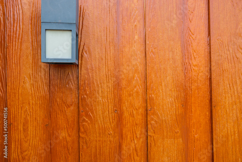 brown wooden wall lamp for light in the night and decorate the front garden or fence.