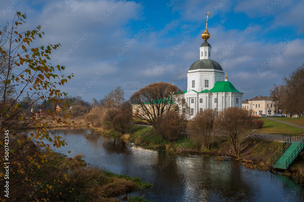View of the Vyazma Museum of Local History located in the Bogoroditskaya Church on the banks of the Vyazma River on a sunny autumn day with clouds, Vyazma, Smolensk region, Russia