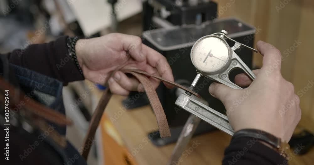 Craftsman working with leather in a workshop Craftsman working with leather in a workshop