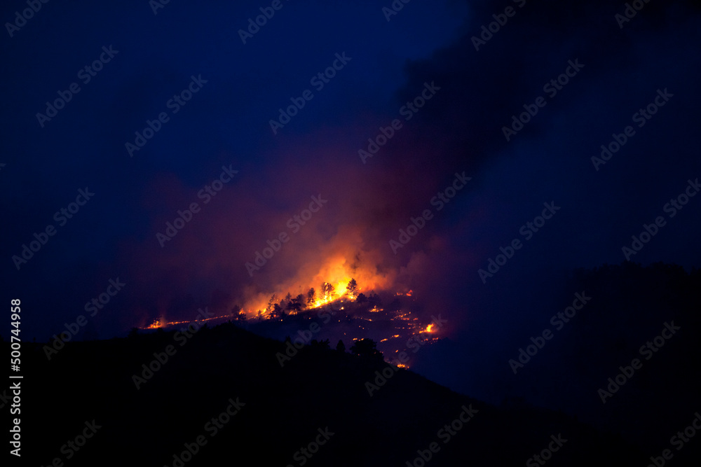 Flames and smoke on the mountain side at the Indian Gulch Fire. March 3rd, 2011 in Golden, Colorado.