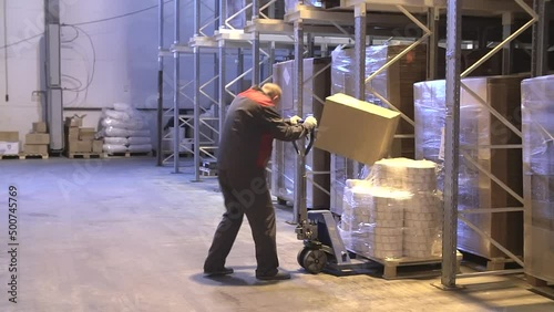 Injury at work. Warehouse worker lying unconscious on the concrete floor after the fall. Dangerous accident at the warehouse. Logistics and safety concept.